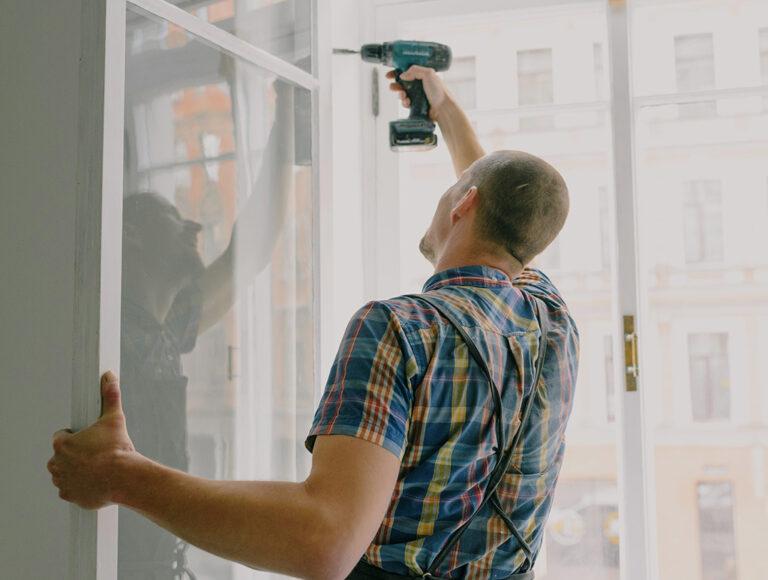 man_drilling_windowframe